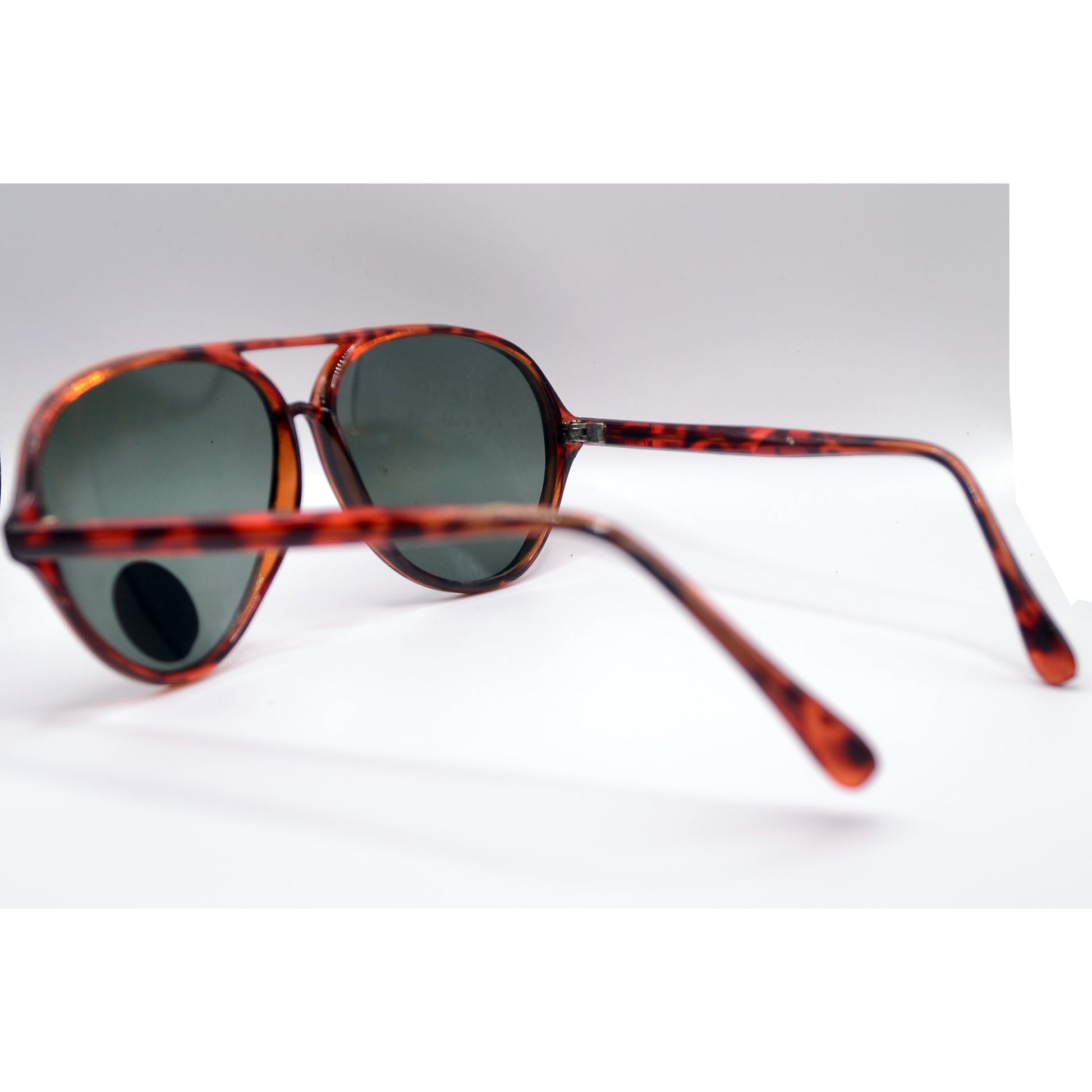 A pair of aviator-style sunglasses with tortoiseshell frames and dark gray lenses. 