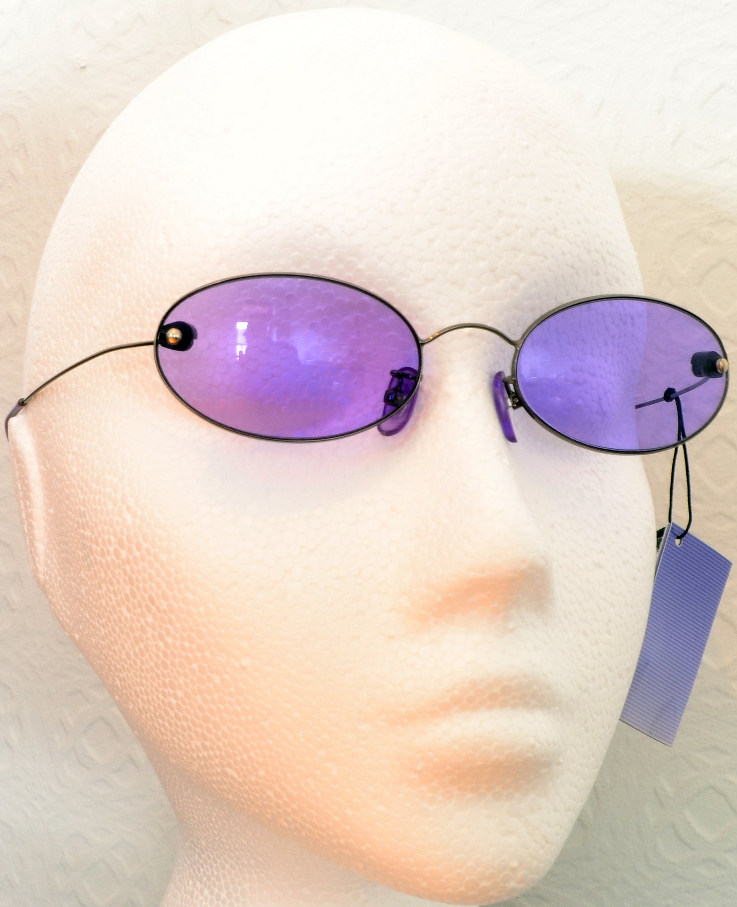 Oval sunglasses with purple lenses